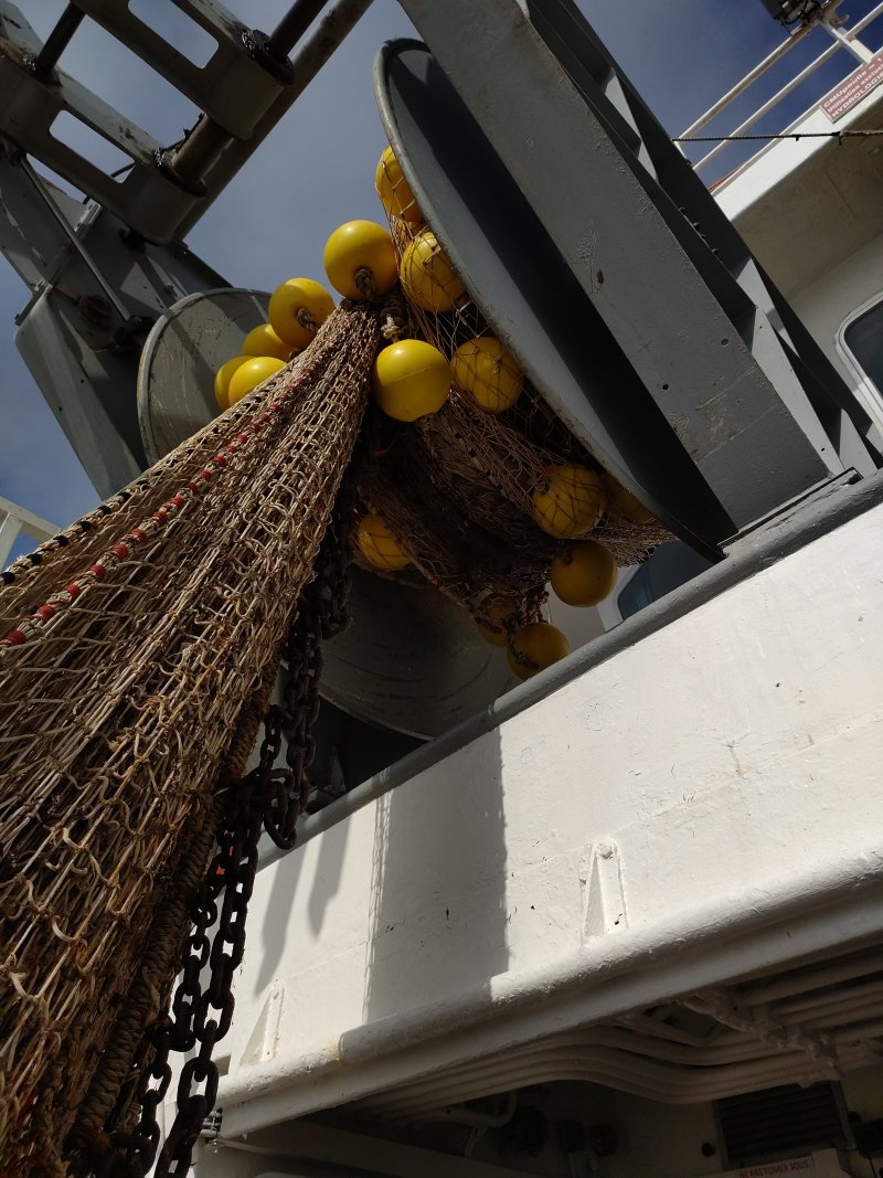 The trawl net and its yellow floats on L'Europe's working deck