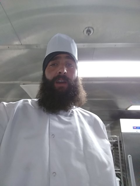 Bastien en veste de cuisine, dans la cuisine du Girolata